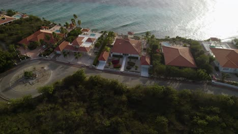 Aerial-trucking-shot-of-the-waterfront-houses-on-the-tropical-island