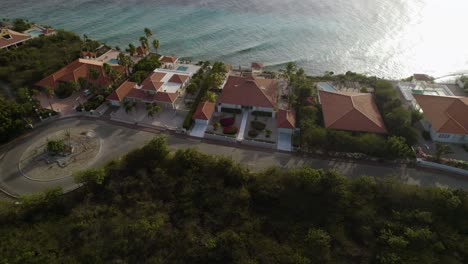 aerial trucking shot of the waterfront houses on the tropical island