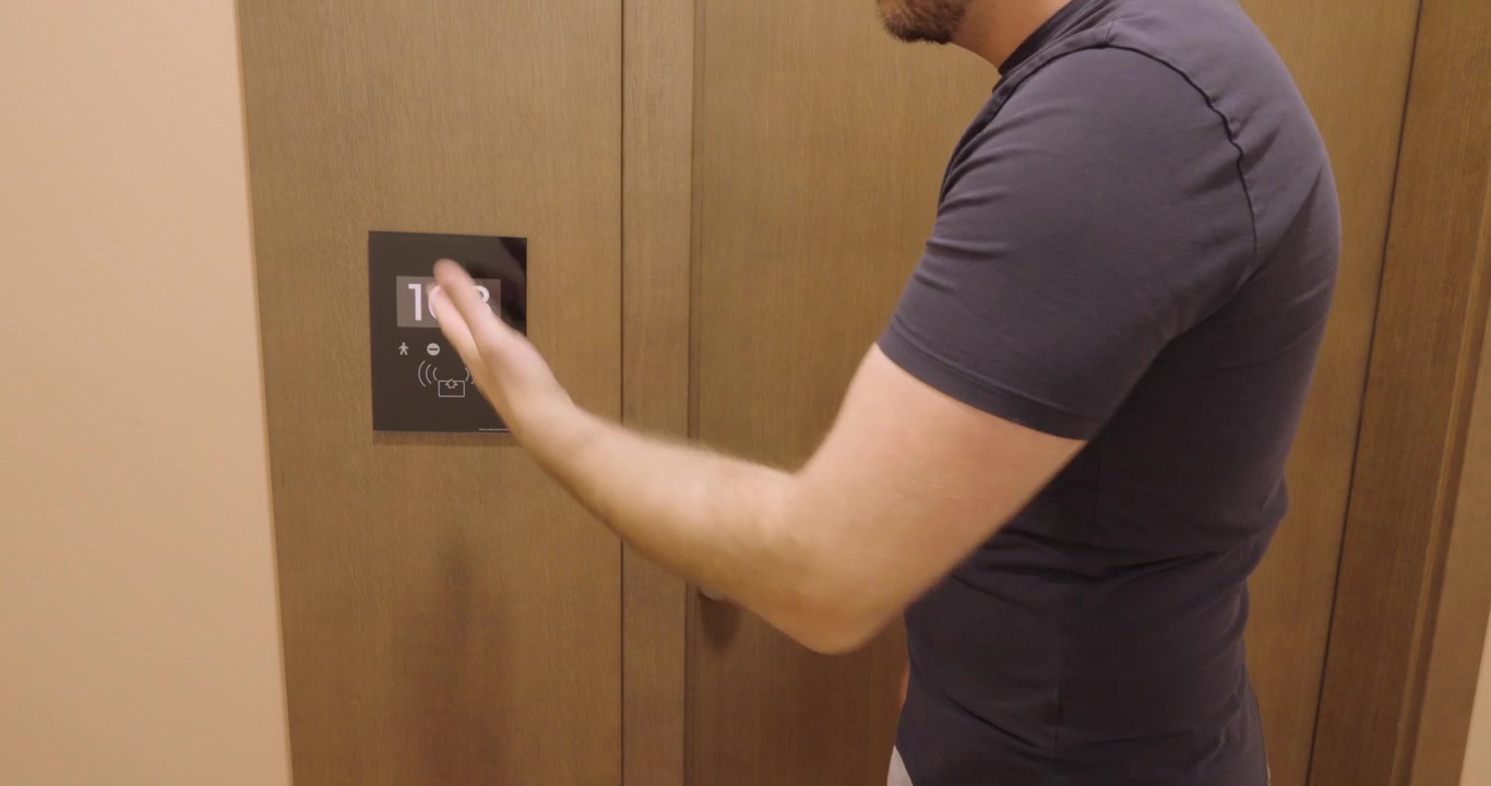 Man searching for his missing hotel key card outside his hotel room and unable to enter. Travel concept of lost room key, hotel access problems, and accommodation inconvenience.
