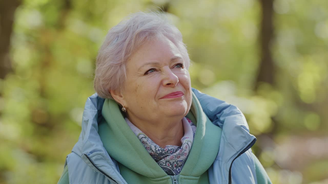 Content Senior Woman Smiling Outdoors in a Park