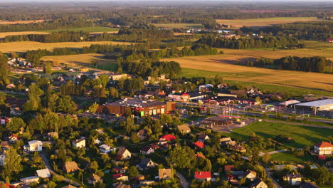 retail shopping center in sigulda, latvia. 4k aerial rotation over the suburban neighborhood surrounded by new commercial buildings.