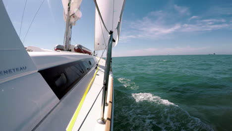 Sailing-yacht,-gliding-across-the-deep-green,-tropical-sea-in-Thailand