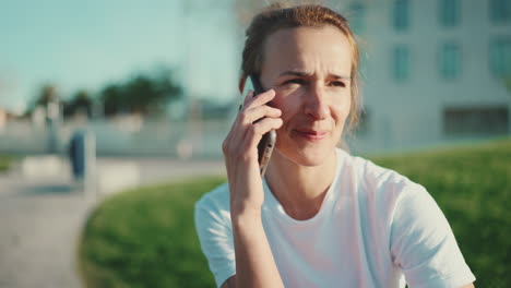 smiling sporty woman talking on the mobile phone phone outdoors.