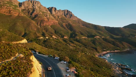 scenic coastal drive along chapmans peak road in cape town at sunset, aerial