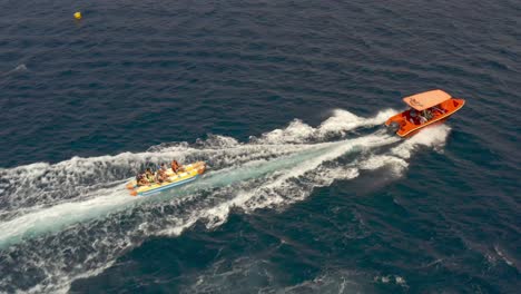 boat towing an inflatable tube on the ocean