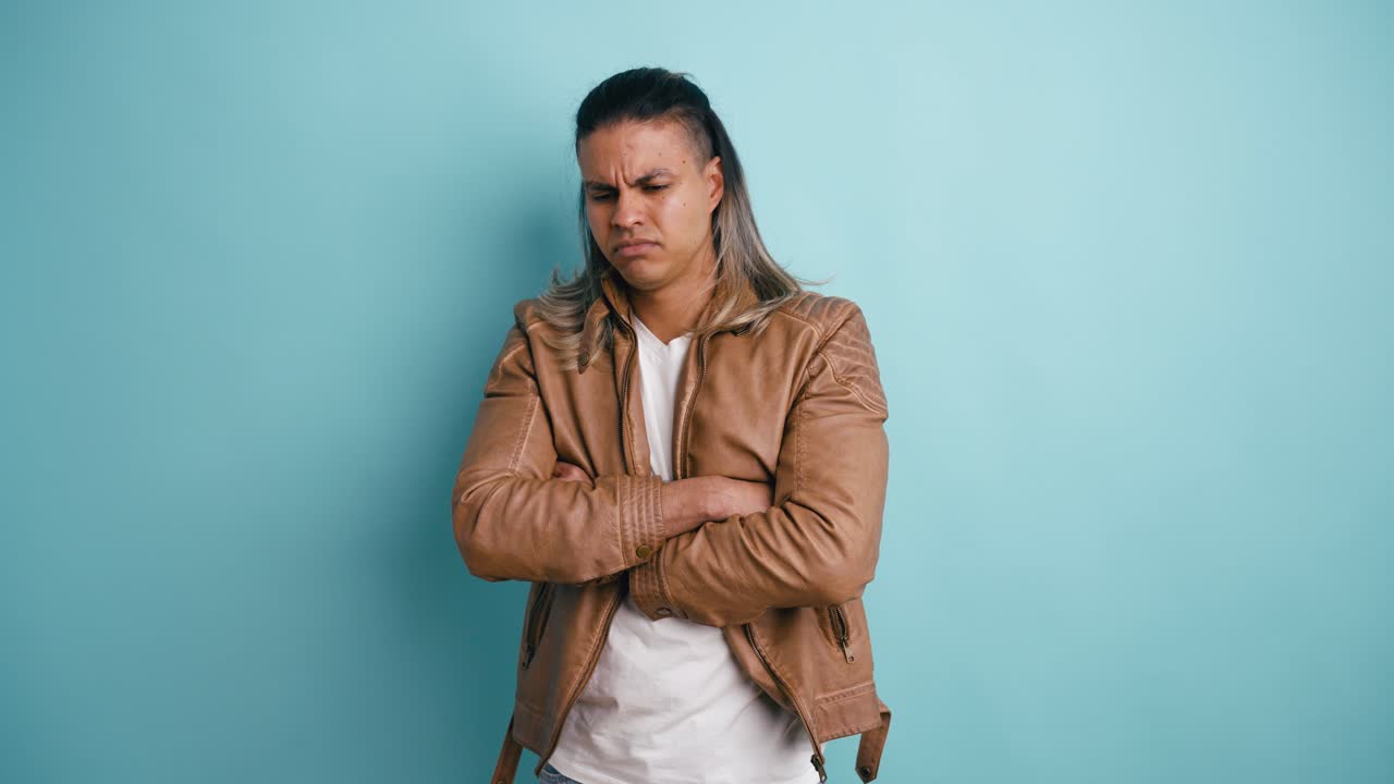 Disappointed Man with Arms Crossed Shaking Head