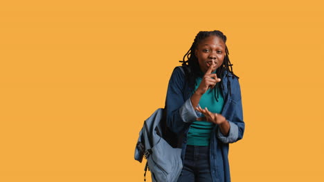 Stern-woman-doing-shushing-hand-gesturing,-studio-background