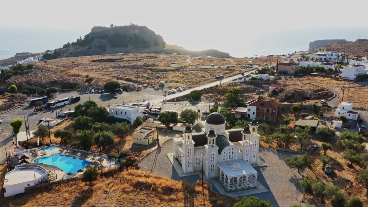 Aerial view of Lindos, Greece featuring a church and historical sites