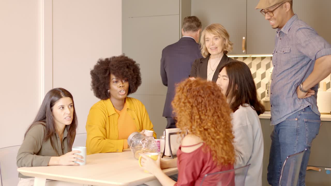 Colleagues of a coworking in a break drinking coffee