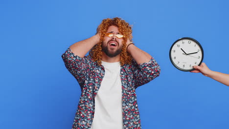 stylish man with anxiety checking time on clock running late to work being in delay deadline