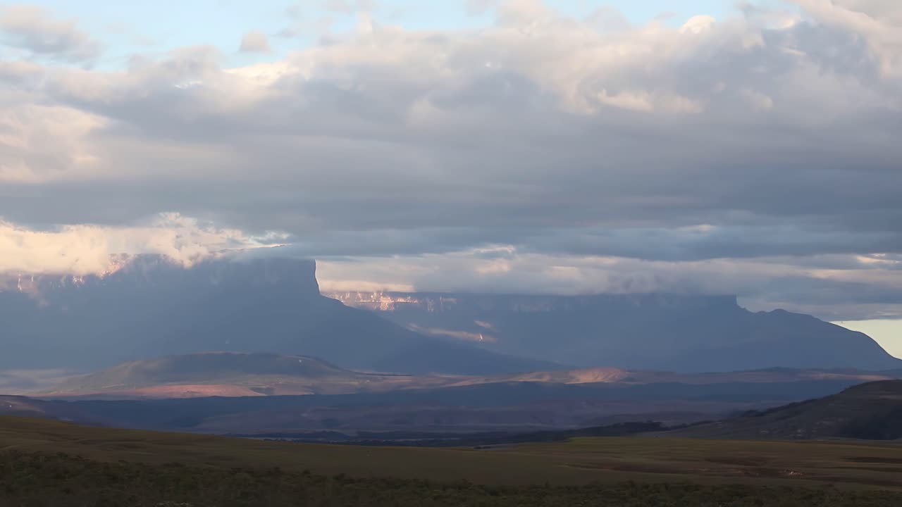 Time lapse of Tepuyes Kukenán and Roraima South American ancient mountains and clouds moving at sunset
