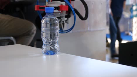 robot handling a water bottle