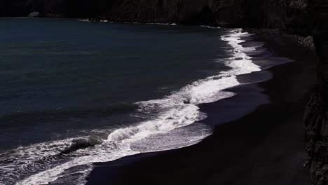 another view of dramatic waves hitting this black sand beach