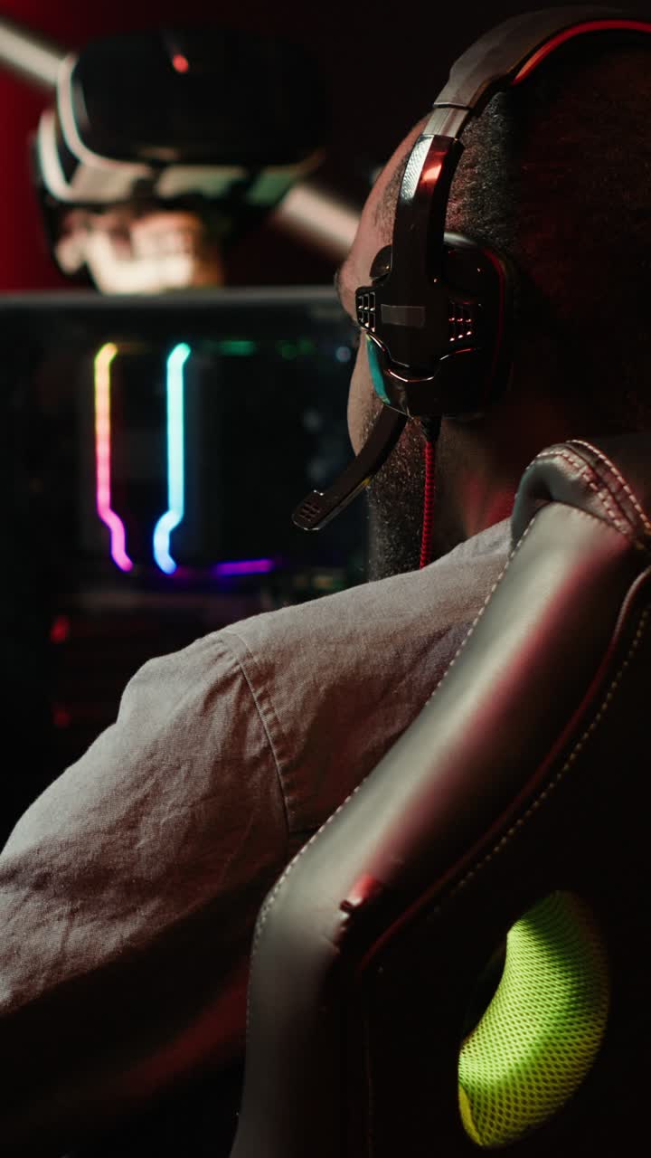 Vertical video Man having fun playing videogames on desktop computer