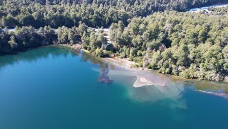 Beautiful-forest-and-lake-with-muddy-water-because-of-river,-aerial-view