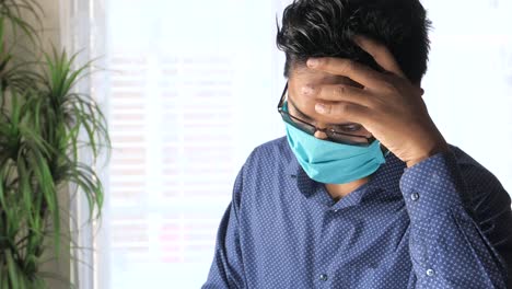 man wearing mask and looking concerned