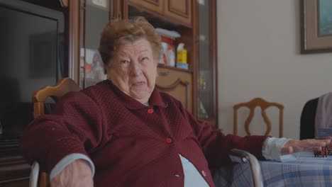 happy granny sitting on a table laughing in company