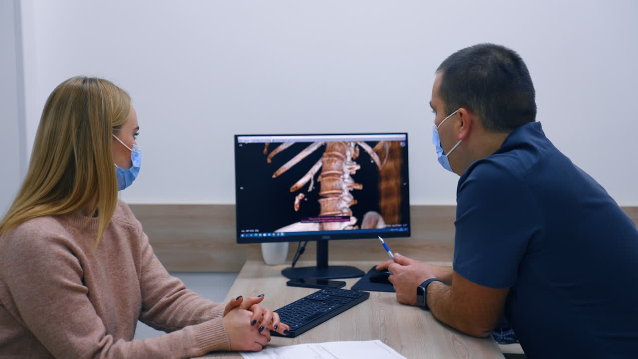 Doctor and patients are focused on the skeleton scan on computer screen. Health consultation at hospital.