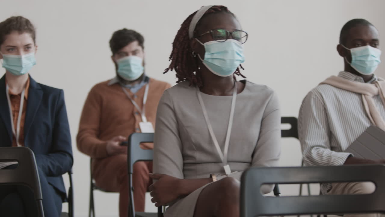 Multiethnic Business Spectators in Medical Masks