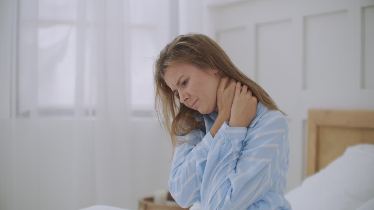 young woman lying in bed in morning feels pain in neck after night sleep awaken having painful sudden ache or stiffness incorrect posture during sleep. Fibromyalgia concept