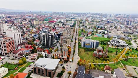 drone captures full skyline and city layout of kosovo's capital in autumn