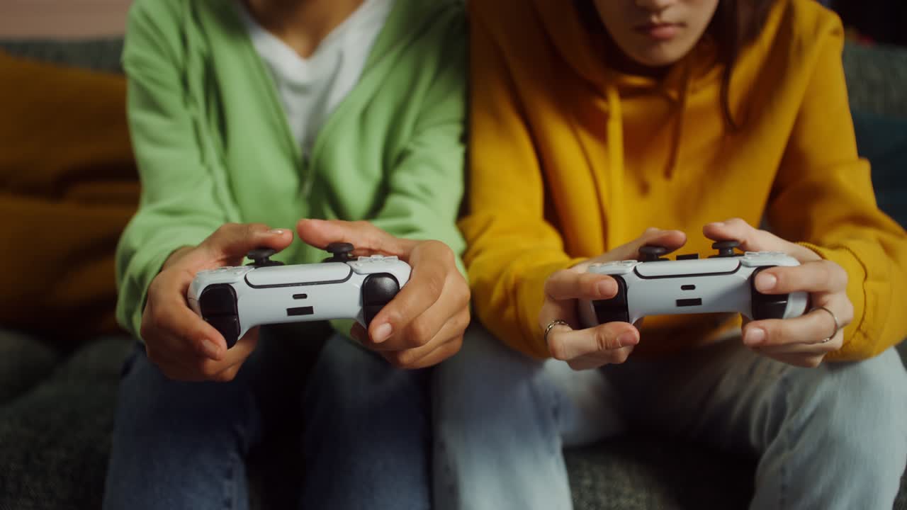 Two people playing video games with controllers
