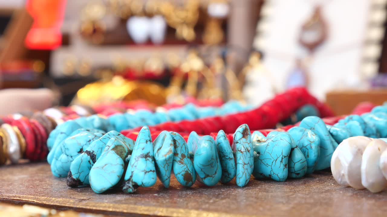 Close-up of Turquoise and Red Beaded Necklaces on Display