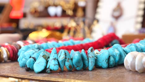 close-up of turquoise and red beaded necklaces on display