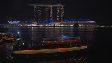 marina bay sands at night from the river