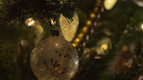 A-close-up-slide-on-Christmas-Tree-ornaments,-bokeh,-selective-focus,-macro,-right-to-left