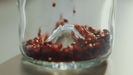 close up shot of aromatic dried spice seeds filling up a glass jar