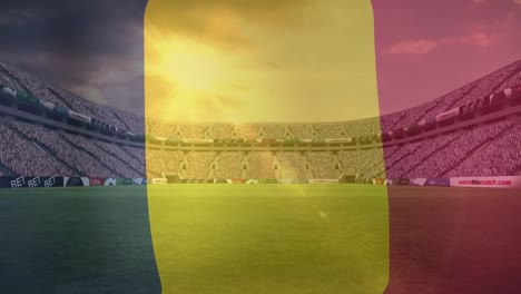 Animation-of-waving-belgium-flag-against-view-of-a-sports-stadium