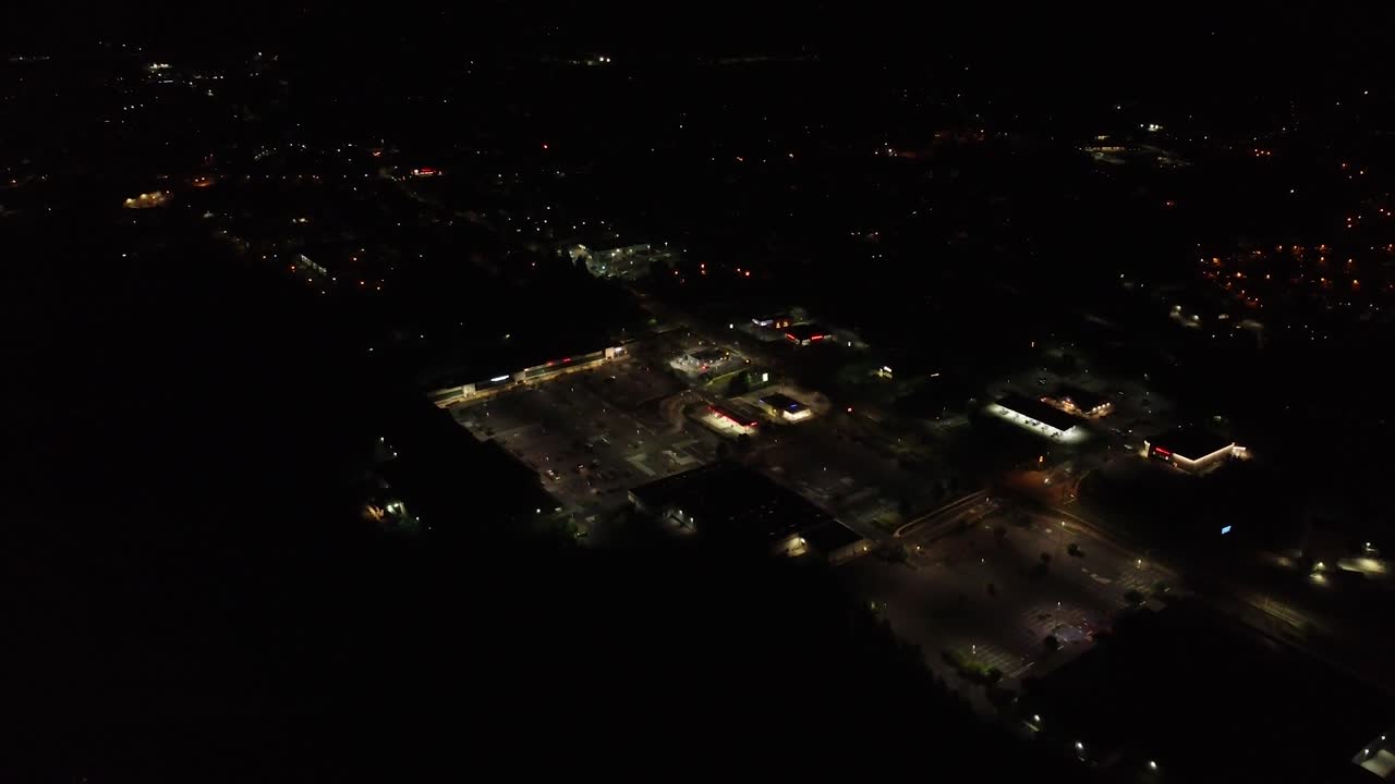 Flying over small town at night