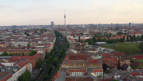 Forwards-fly-above-city.-Aerial-panoramic-view-of-buildings-in-urban-neighbourhood.-Skyline-with-Fernsehturm-TV-tower.-Berlin,-Germany