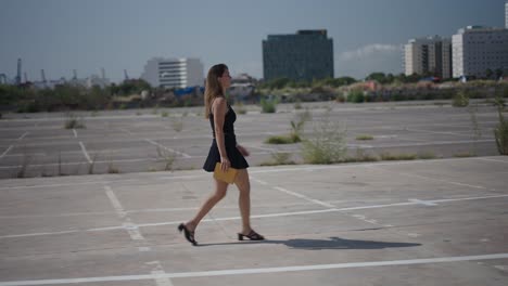 woman walking in an empty parking lot