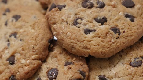 pile of chocolate chip cakes close-up tilting 4k 2160p 30fps ultrahd video - biscuit cookies with pieces of chocolate 4k 3840x2160 uhd slow tilt footage