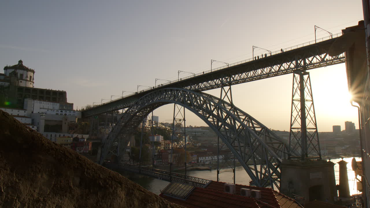 Dom Luis I Bridge and Porto cityscape during sunset, handeld view