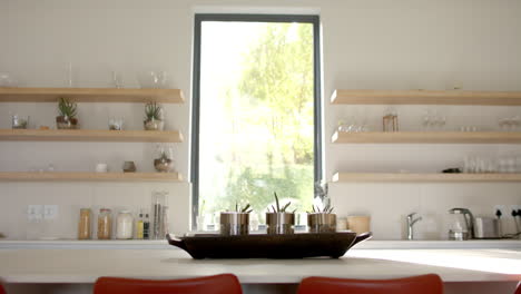 airy kitchen with open shelves and big window view