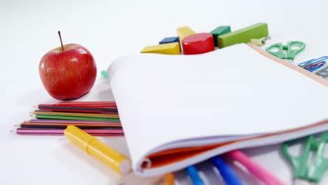 Apple-and-stationery-on-white-background