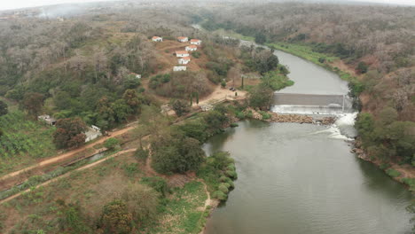 Traveling-down-over-a-river,-dam-on-a-river-in-Angola,-Africa