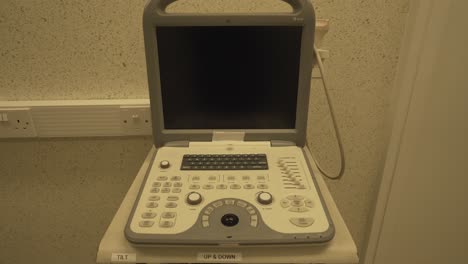 ultrasound machine in human hospital with black screen and keyboard for diagnostic imaging procedures