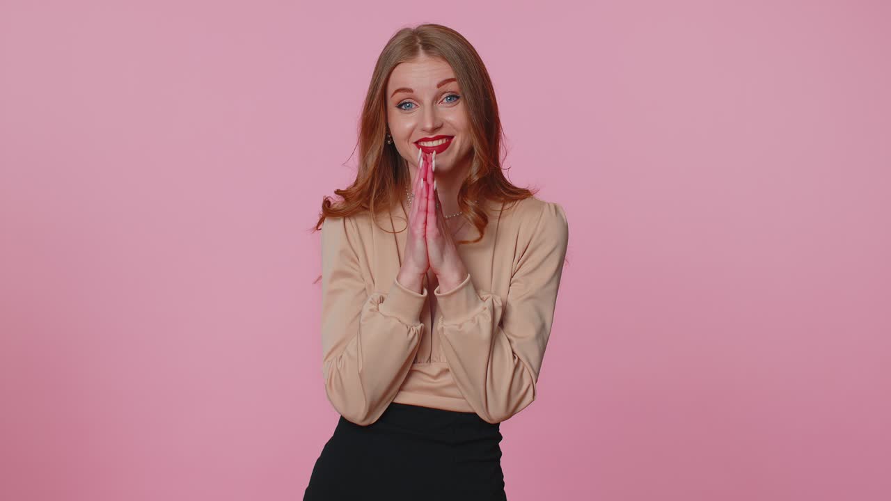 Businesswoman praying looking upward and making wish asking with hopeful imploring expression