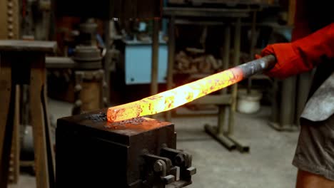 blacksmith shaping hot metal rod in machine 4k