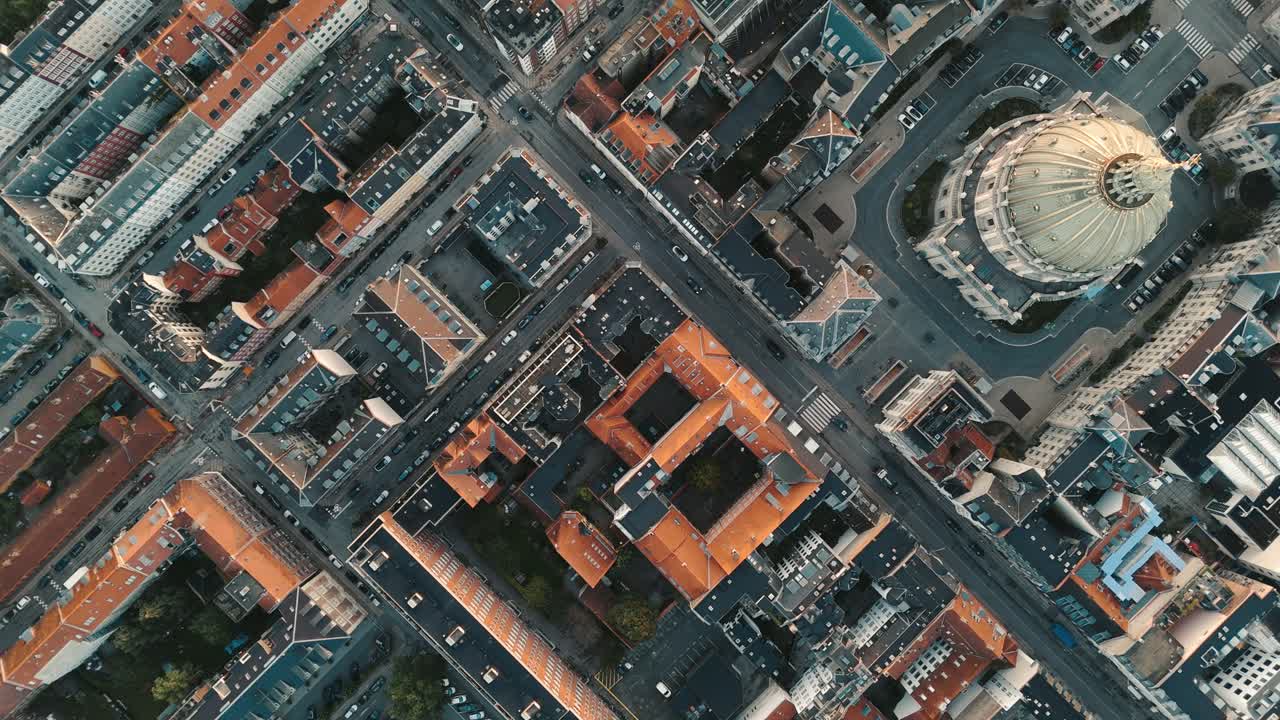 High birdseye tracking view of Copenhagen city at sunrise with passing cars and Frederiks Kirke