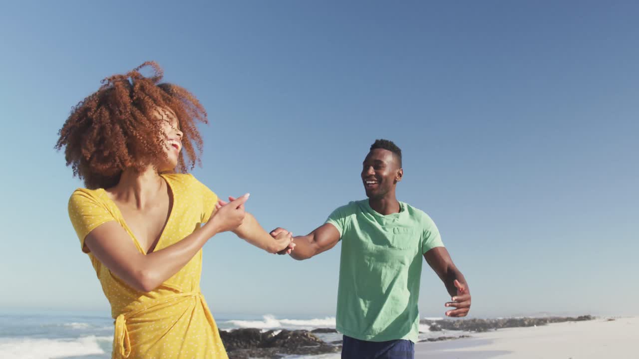 African American couple playing seaside