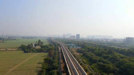 aerial drone shot capturing a massive metro line site in noida india