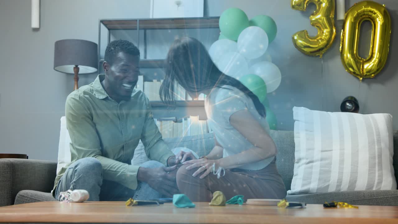 Couple decorating while woman popping confetti popper celebrating 30th with teal balloon for events