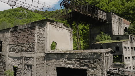 Desolate-buildings-and-rusty-cableway-of-abandoned-factory,-Georgia