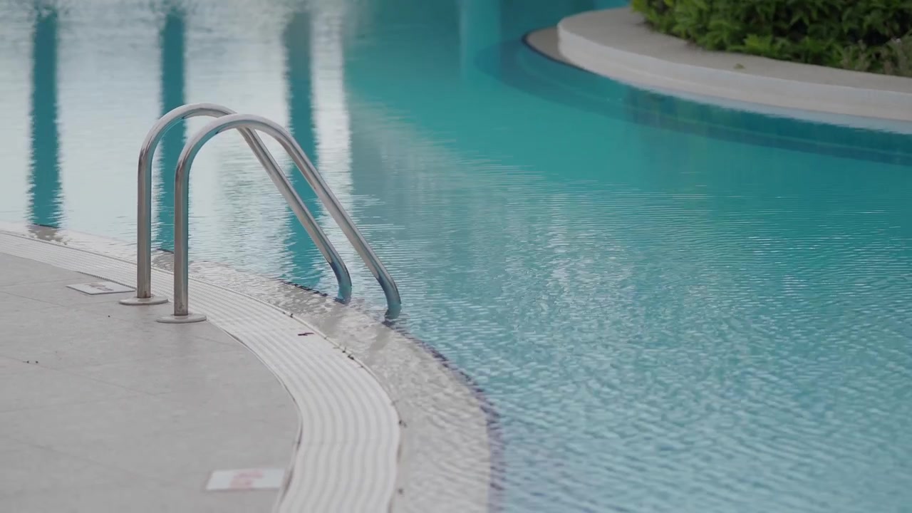 Stainless Steel Ladder at the Edge of a Swimming Pool