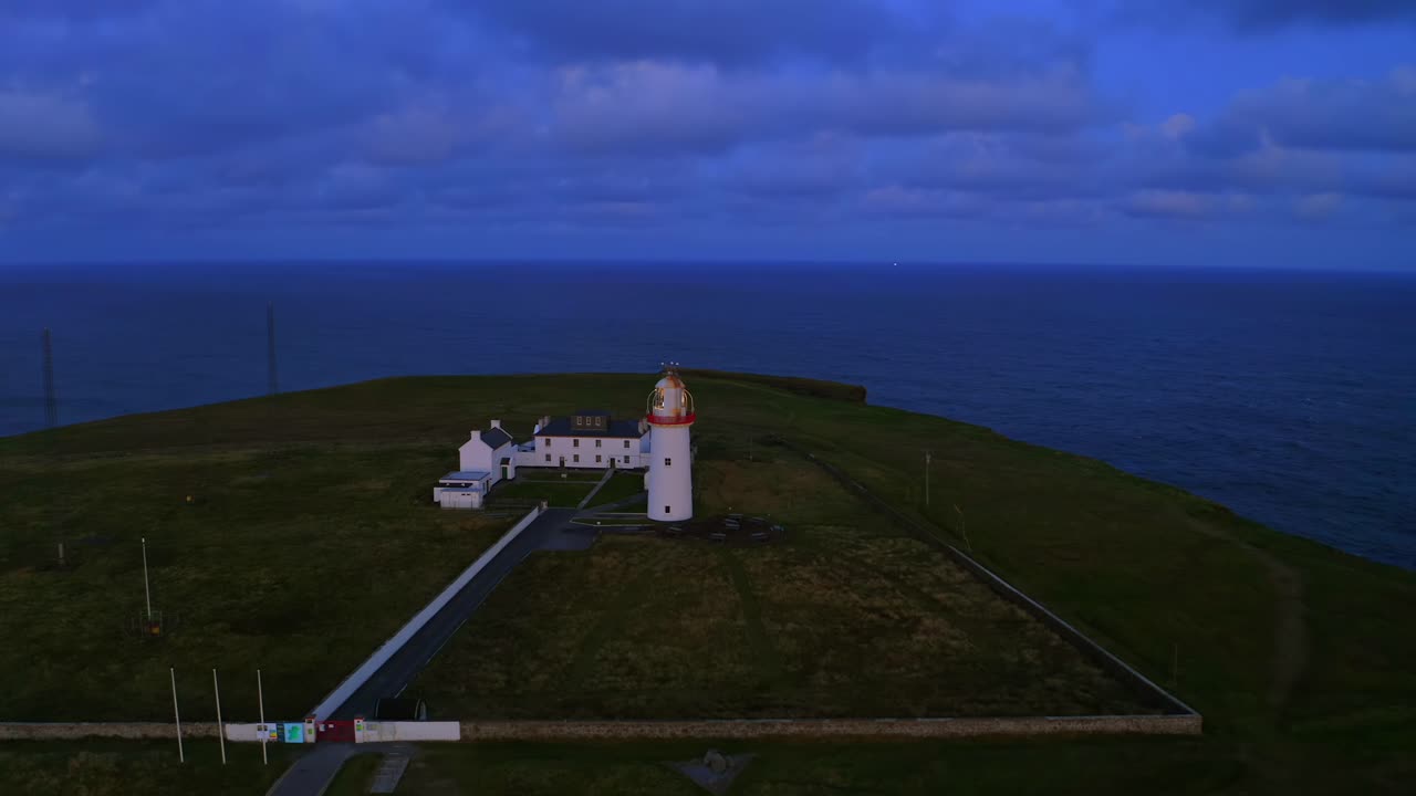 órbita aérea del faro de la cabeza del bucle, mostrando el océano atlántico en toda su majestuosa gloria al amanecer